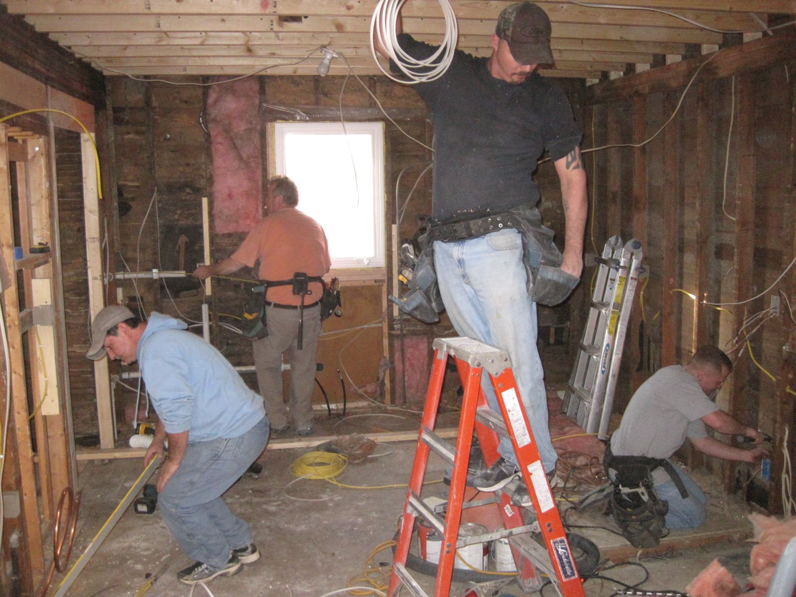 Carpenters, ventilation workers, electricians, all at work.  Not pictured:  plumber, plumbing inspector, laborer, general contractor.