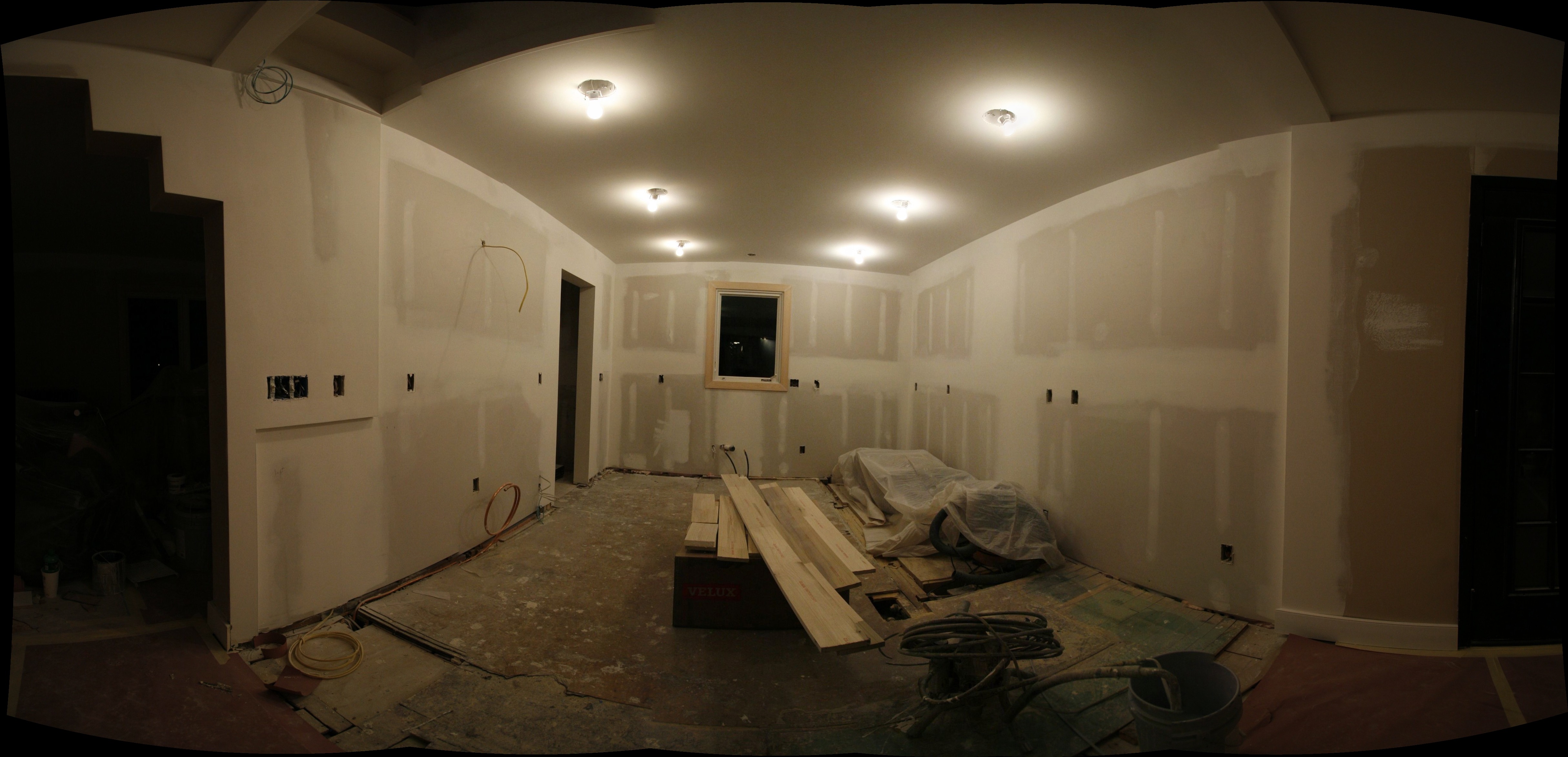 The kitchen walls now cover the wiring and plumbing behind the veneer of drywall, taped, mudded, and sanded to smooth, flat, vertical, and level.