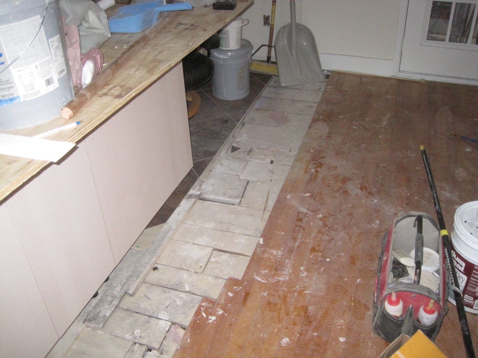 The no man's land between the kitchen vinyl floor and the maple floor to be restored.  Somehow, they will have to come together.