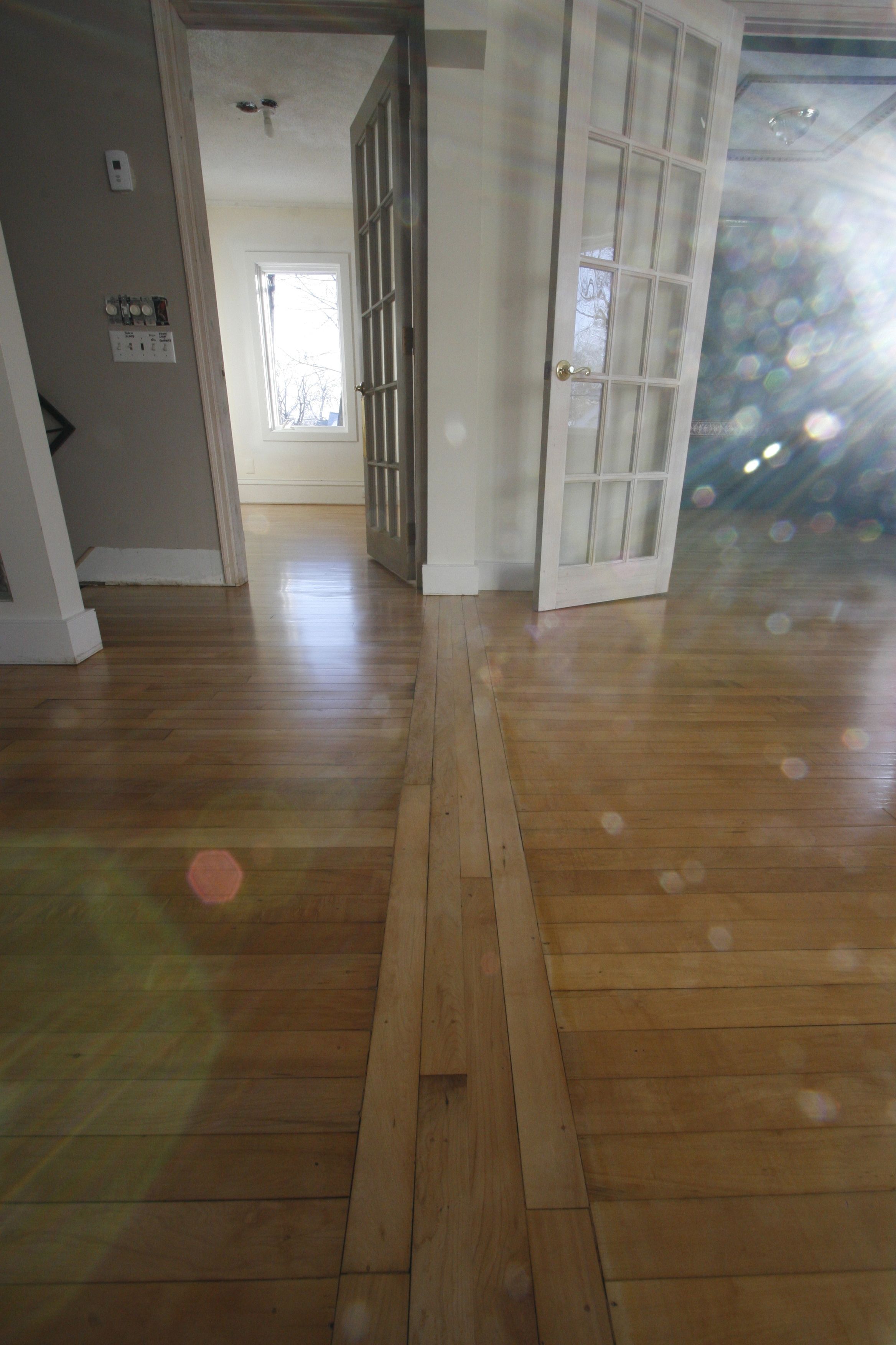 A newly refinished wood floor gleams in the morning light.