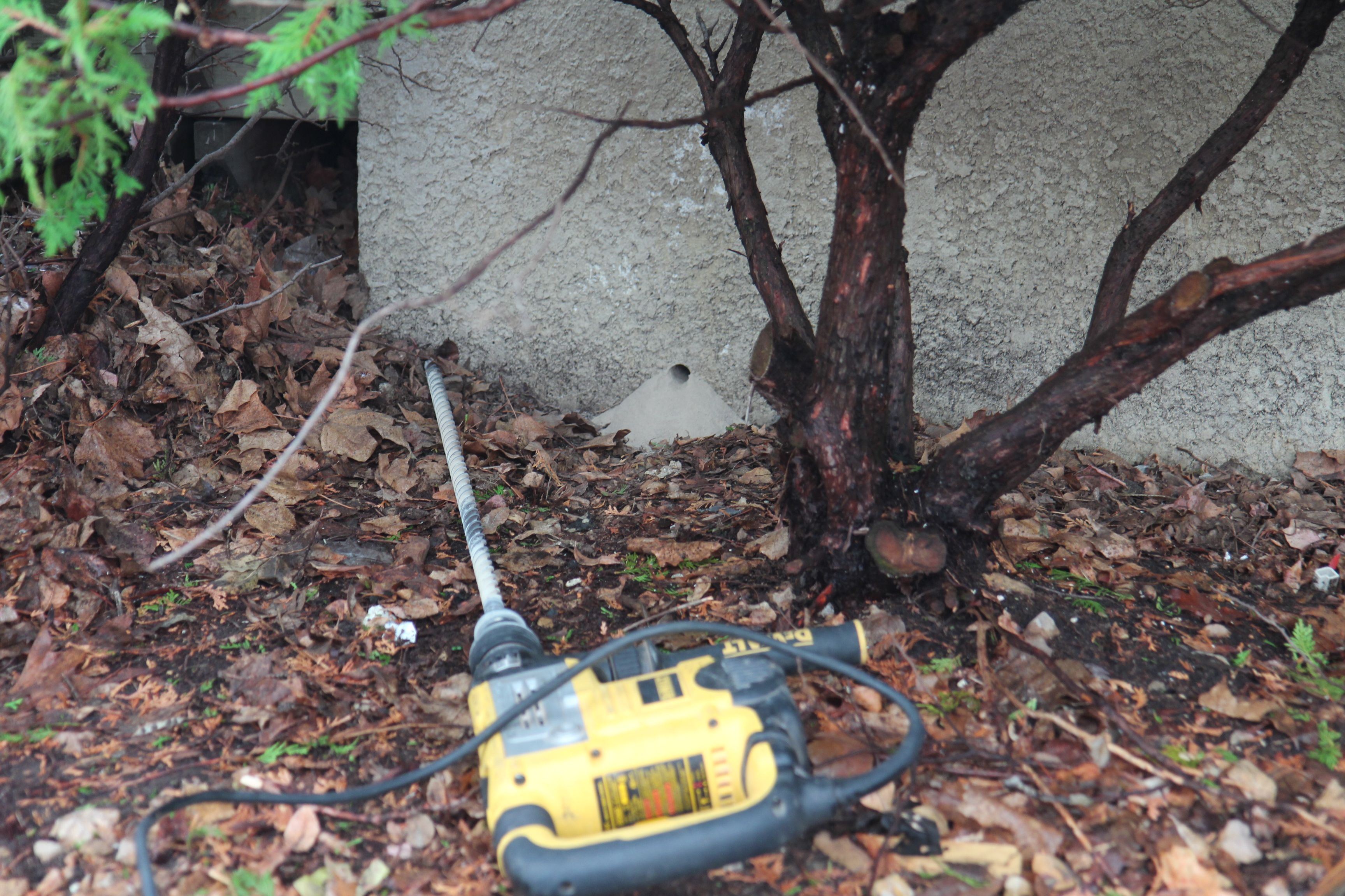 The drill went in as far as it could go, but did not emerge on the inside wall.  I speculate that it was drilling into the side foundation wall (1-1/2 foot thick).