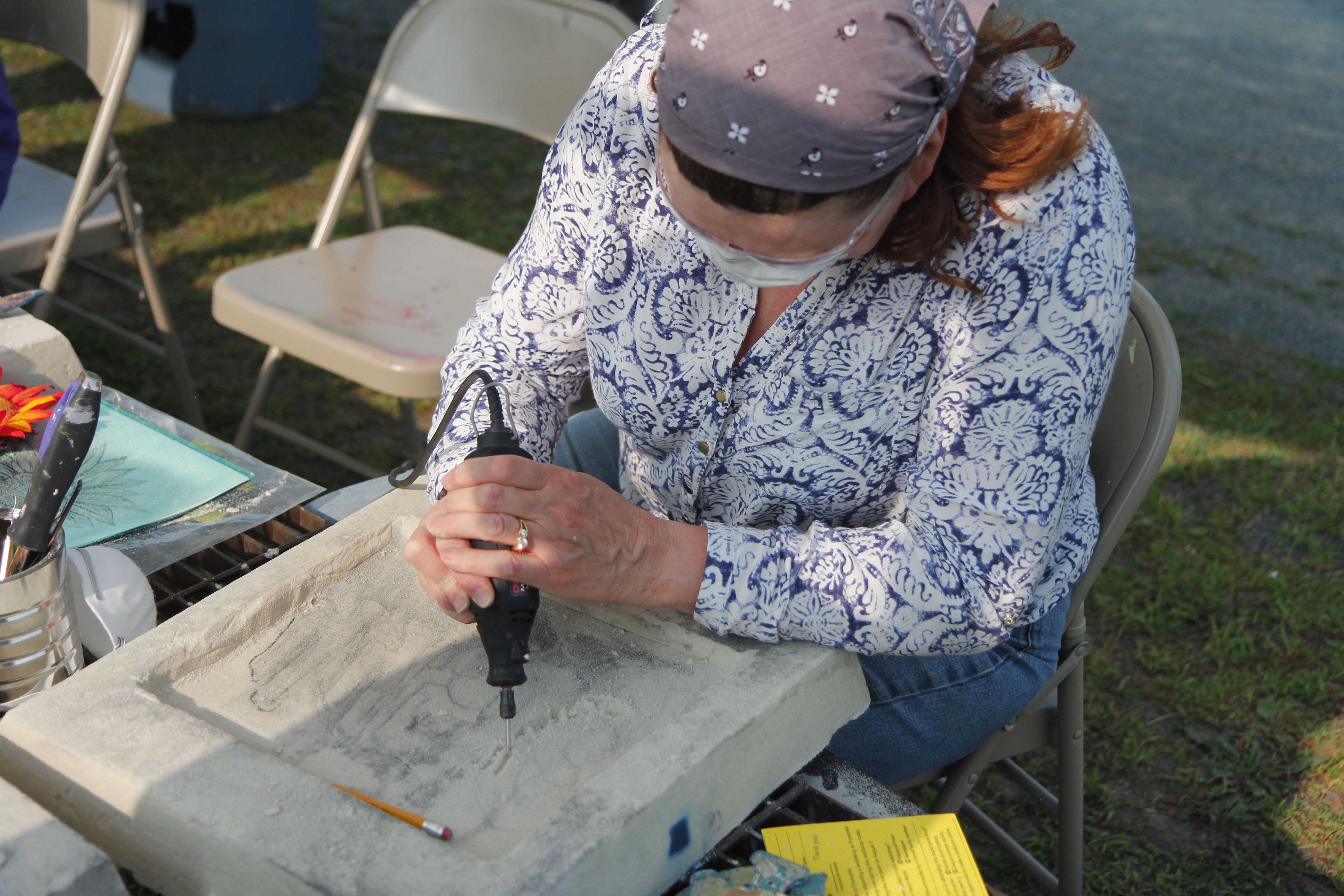 Portia working the dremel to create the negative image for her mold.