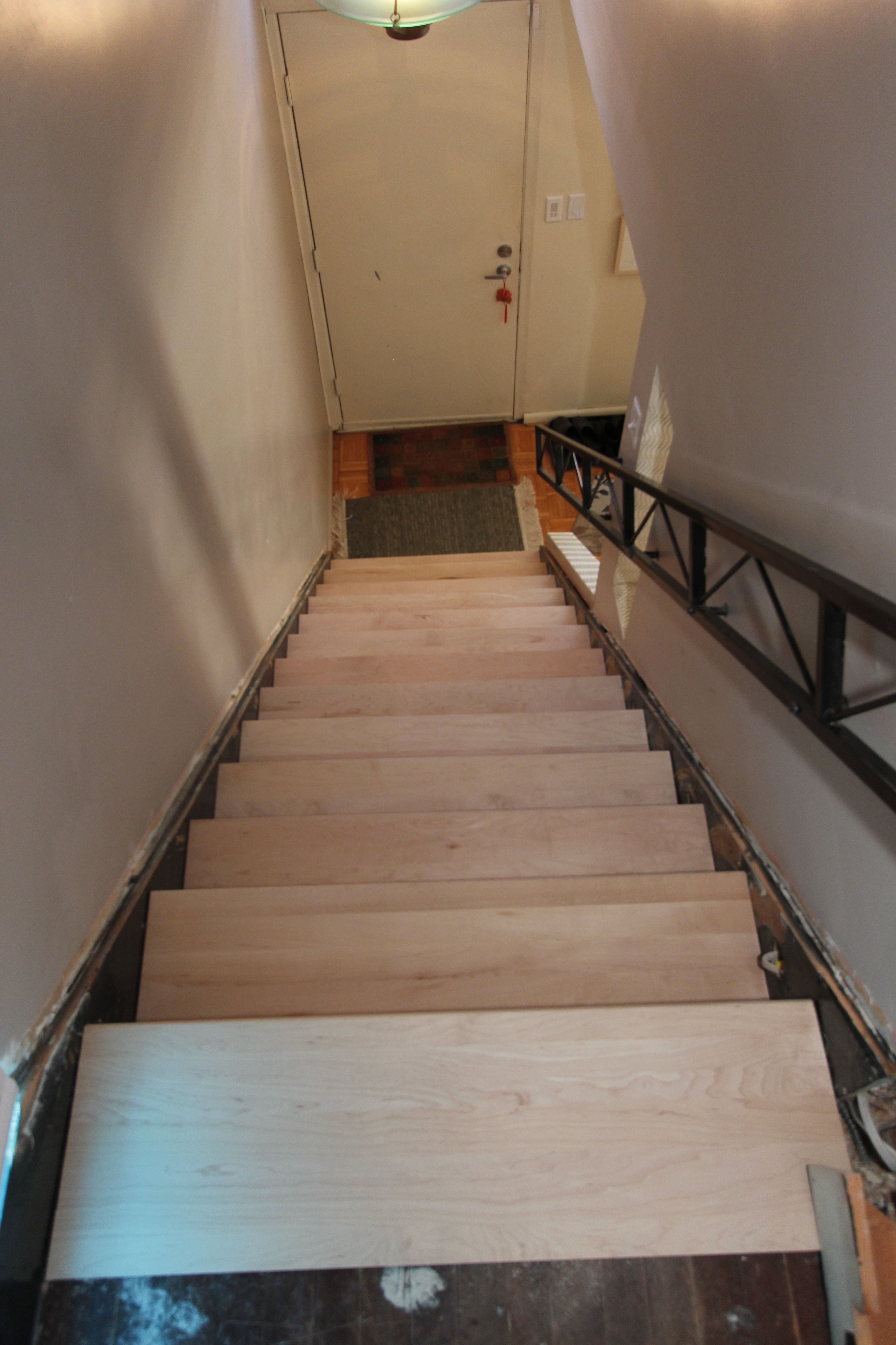 A view down the stairway with the straight treads in place, prior to being shaped.