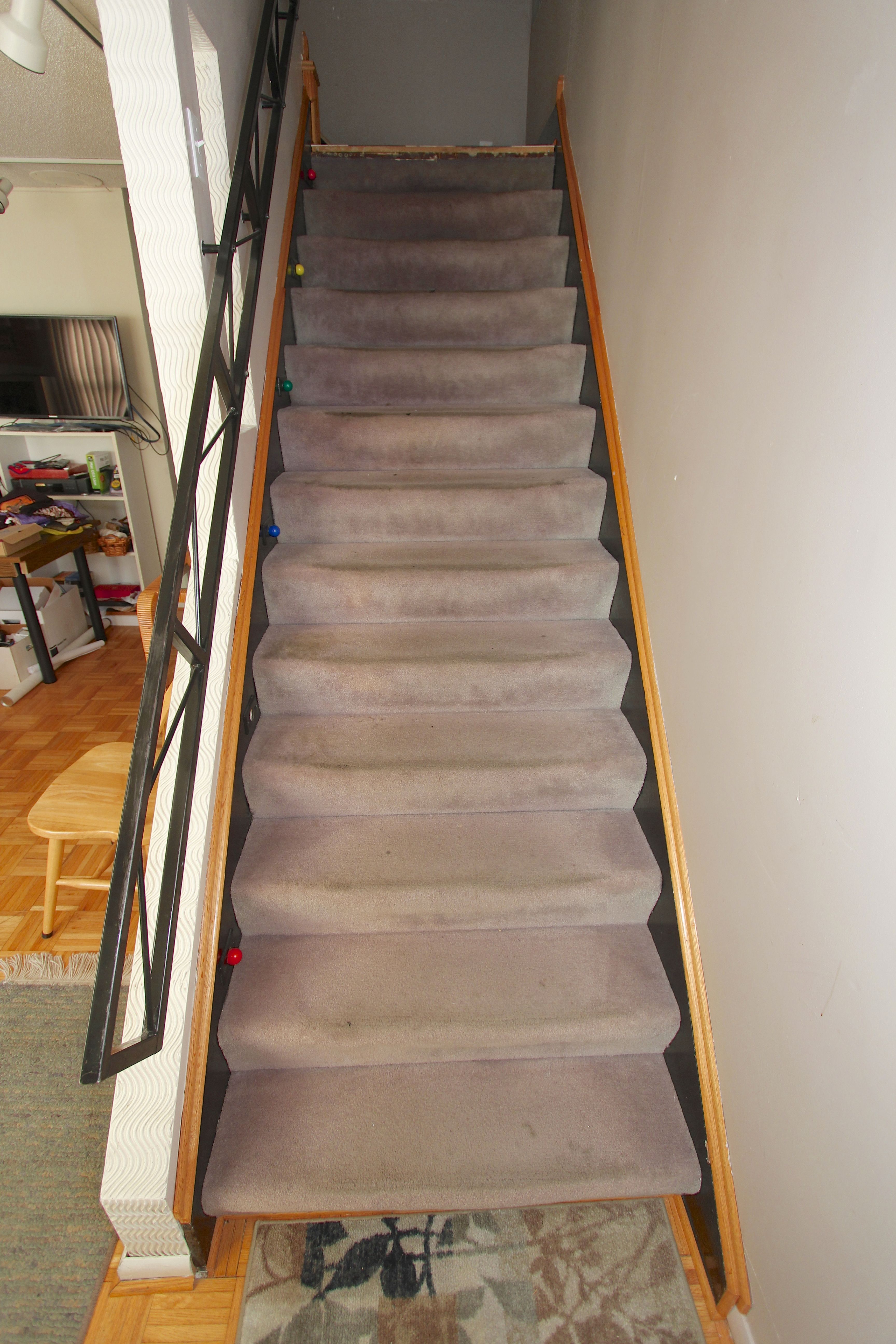 The beat up gray carpeted stairway leading to our newly renovated upstairs space desperately needed renovation itself.